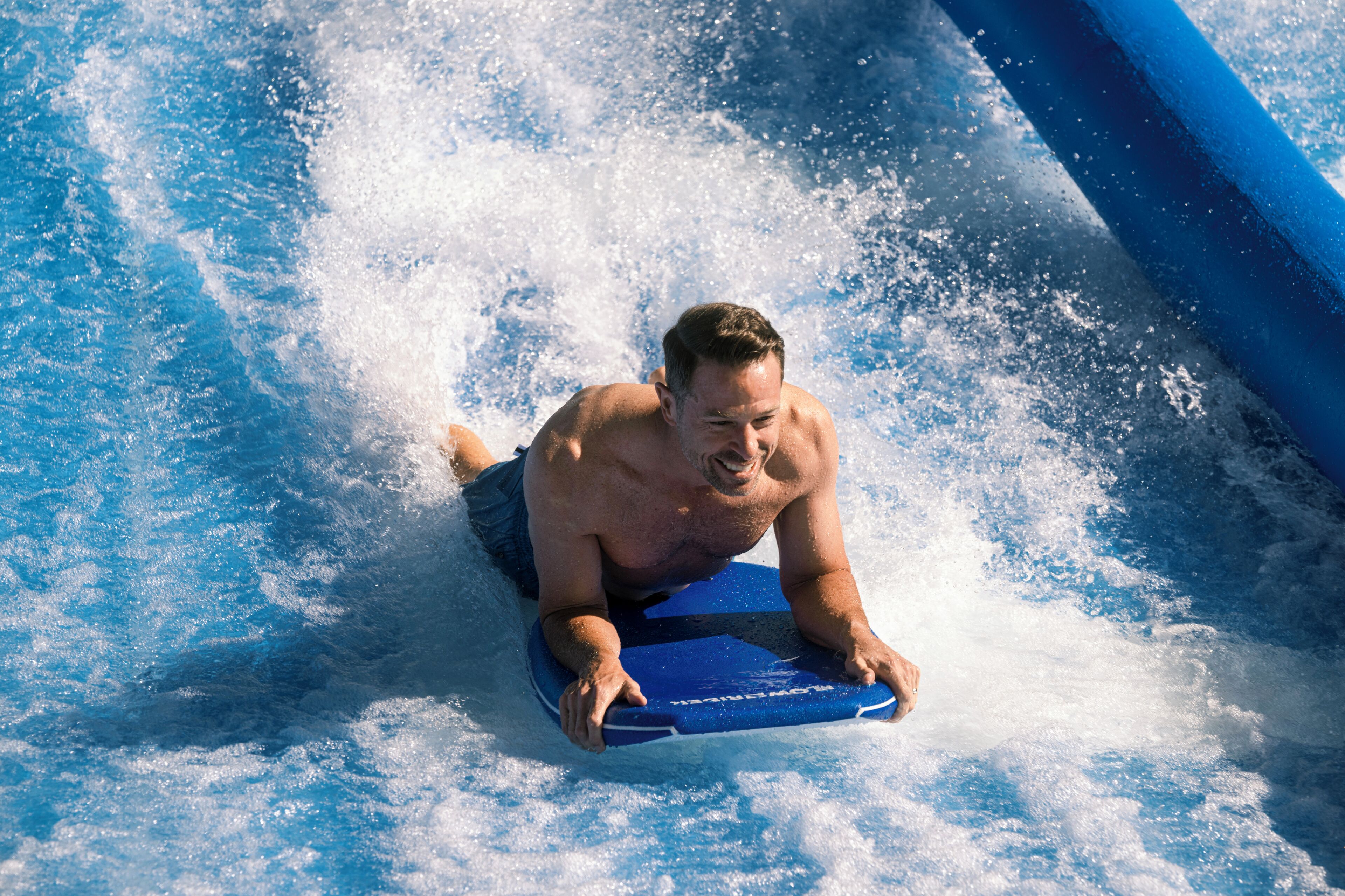 A person on a blue water slide.