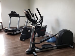 A home gym with an elliptical, a treadmill, and a stationary bike. - Holiday Inn Express Edgewood-Aberdeen-Bel Air by IHG (Edgewood)