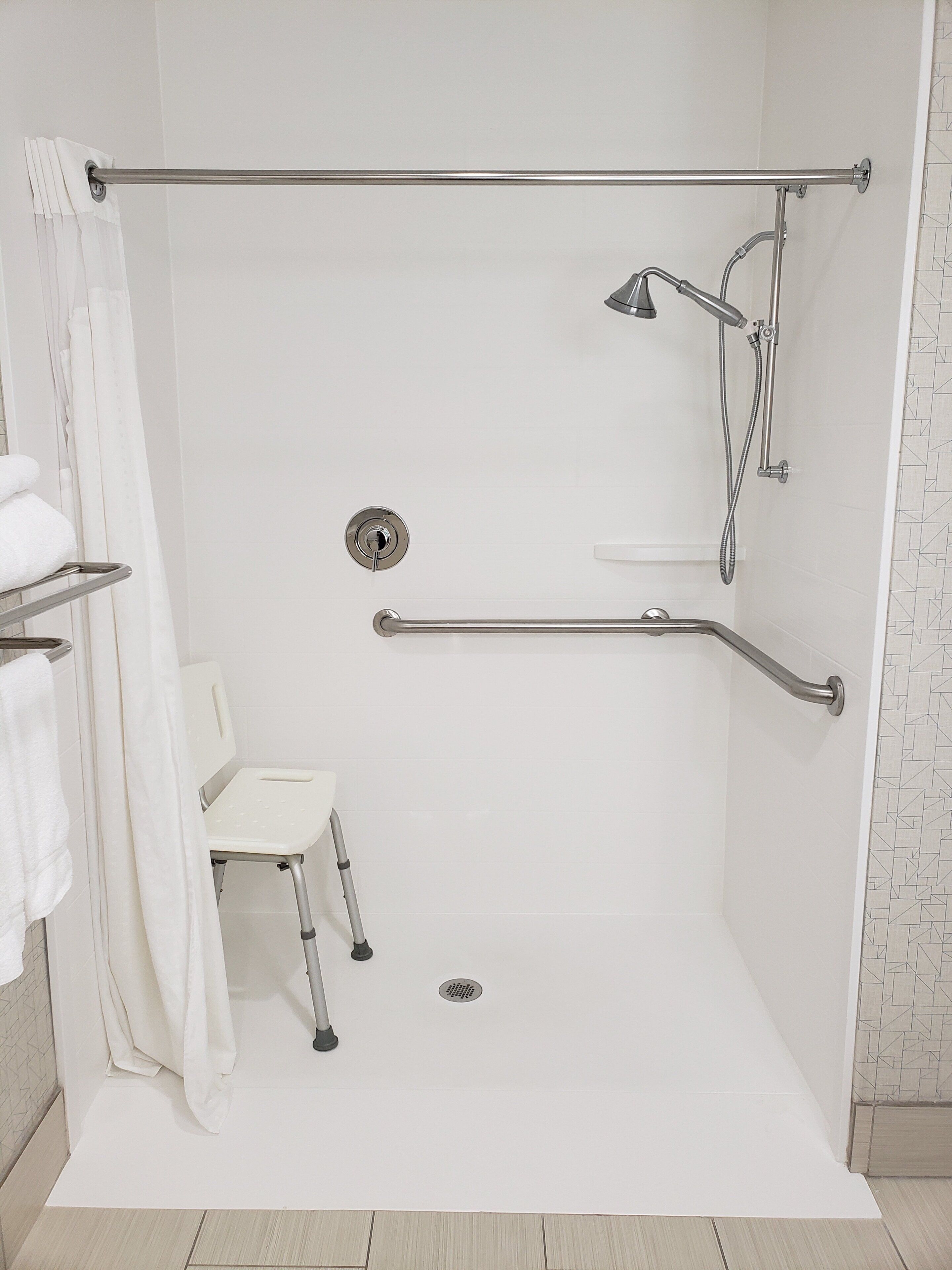 standard room, 1 king bed, roll-in shower (mobility) | bathroom | hair dryer, towels