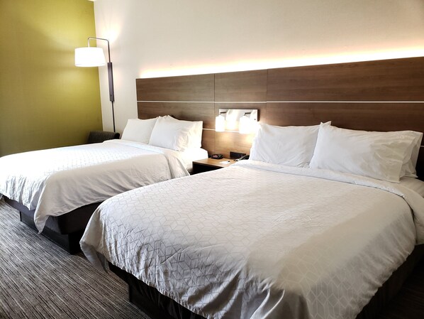 A hotel room with two beds, a nightstand with a lamp, and a wooden headboard. - Holiday Inn Express Edgewood-Aberdeen-Bel Air by IHG (Edgewood)