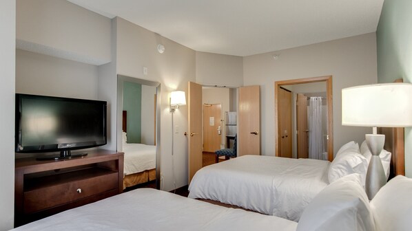 A hotel room with two beds, a television, a desk, and a lamp. - Holiday Inn Express Hotel & Suites St. Cloud by IHG (St Cloud)