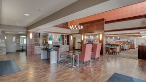 A spacious lobby with a reception desk, seating area, and a coffee bar. - Holiday Inn Express Hotel & Suites St. Cloud by IHG (St Cloud)