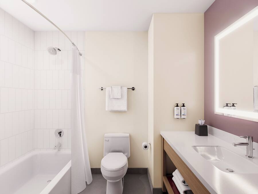 Combined shower/tub, designer toiletries, hair dryer, towels