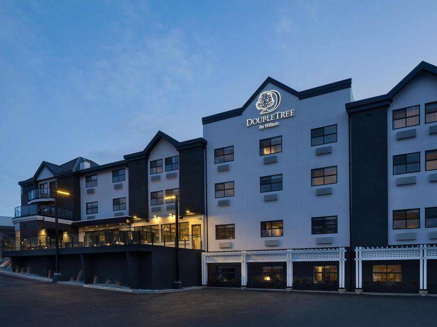 A hotel with a modern design, featuring multiple floors and balconies.