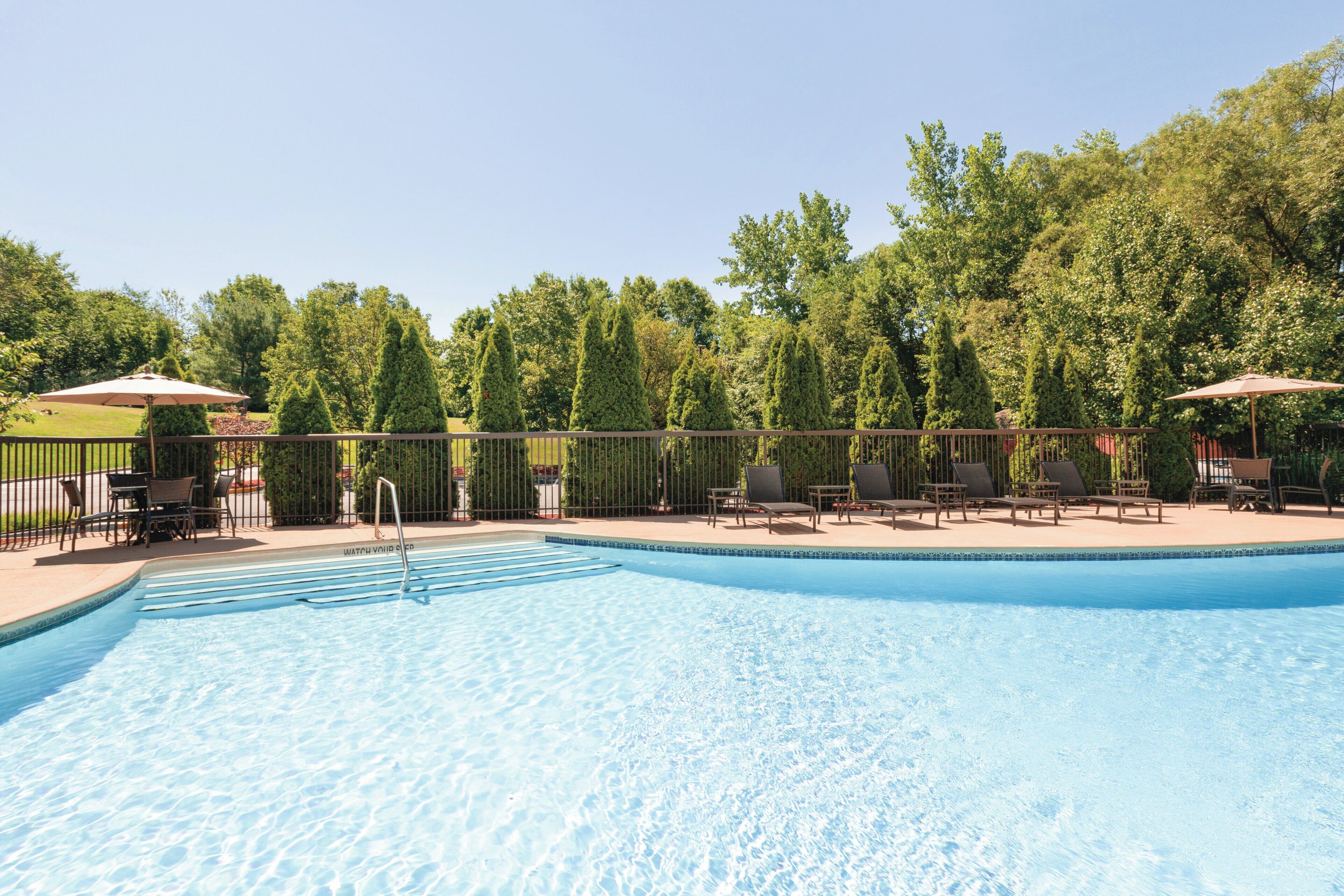 Seasonal outdoor pool, open 9 AM to 9 PM, pool umbrellas, pool loungers