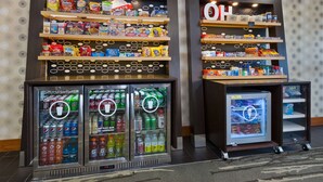 Vending machines stocked with snacks and beverages, and a small refrigerator with a drink dispenser. - Hampton Inn Marysville (Marysville)