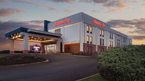 A Hampton Inn hotel with a modern facade, a covered entrance, and a landscaped area in front. - Hampton Inn Athens (Athens)