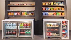 A vending machine with snacks and beverages, including popular brands like Lay's and Fritos. - Hampton Inn Athens (Athens)