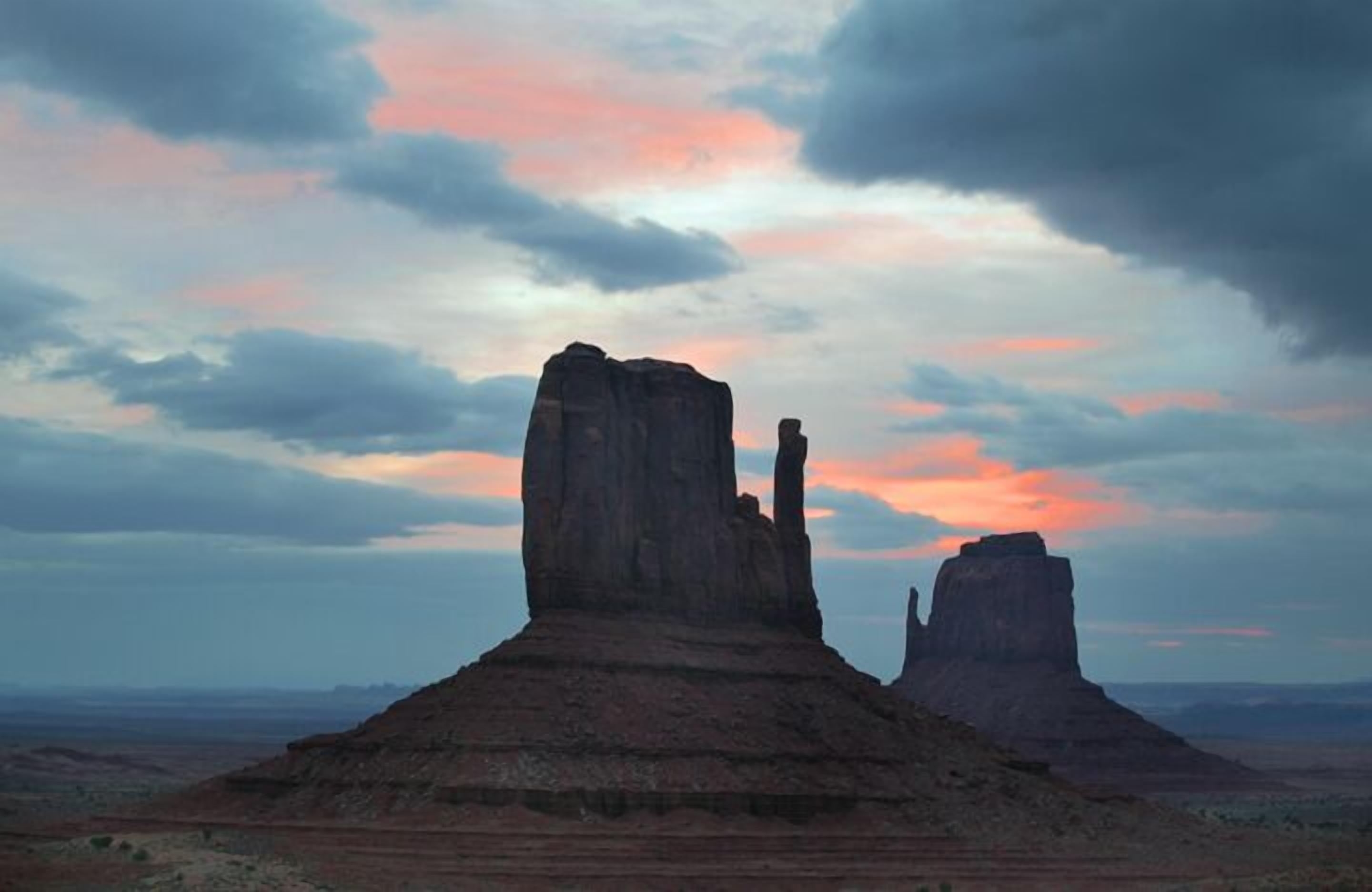 A desert landscape with two prominent rock formations.