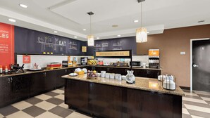 A modern kitchen with a checkered floor, a central island, and various appliances. - Hampton Inn Lancaster (Lancaster)
