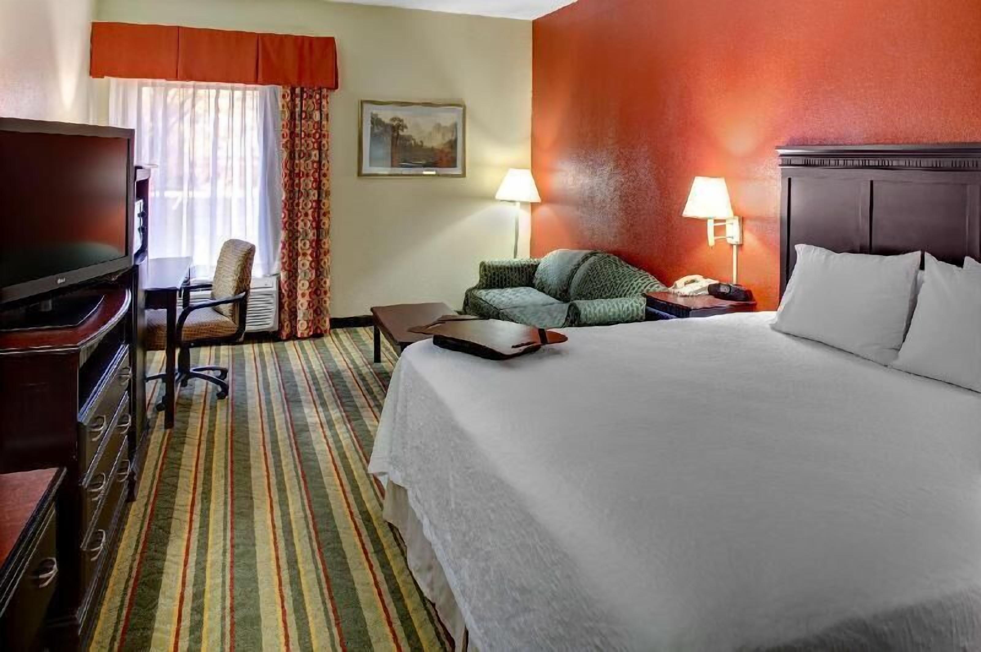 Premium bedding, desk, laptop workspace, blackout drapes