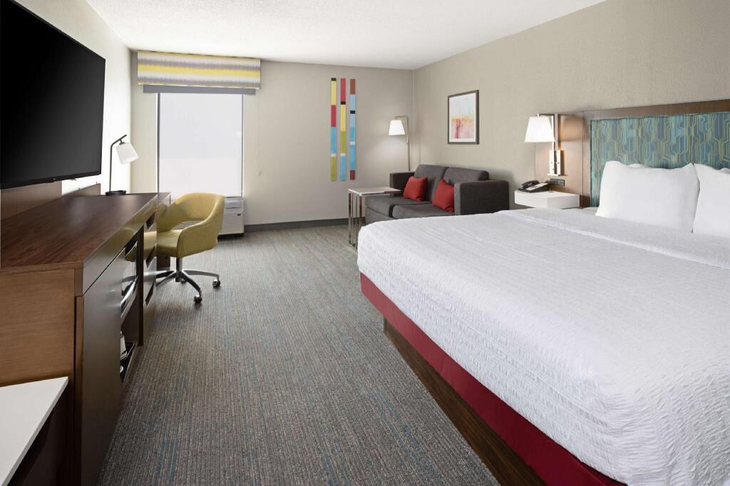 Premium bedding, desk, laptop workspace, blackout drapes