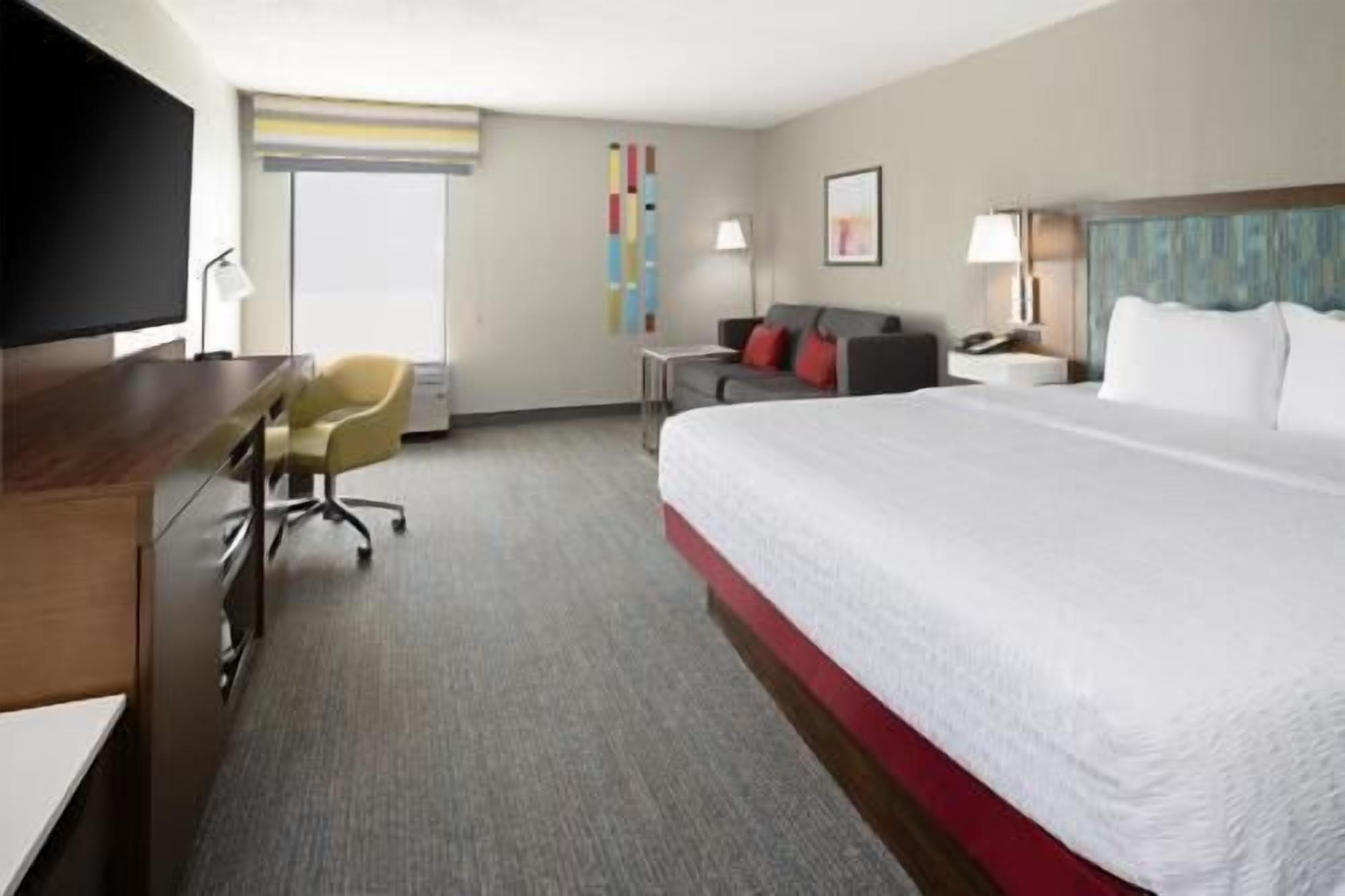 Premium bedding, desk, laptop workspace, blackout drapes