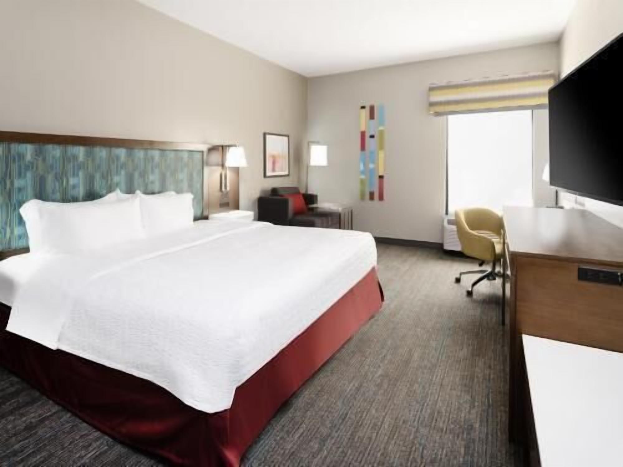 Premium bedding, desk, laptop workspace, blackout drapes
