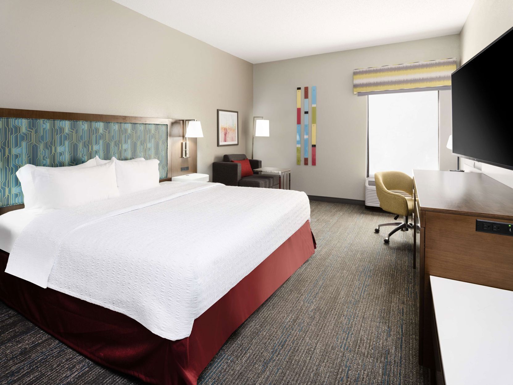 Premium bedding, desk, laptop workspace, blackout drapes