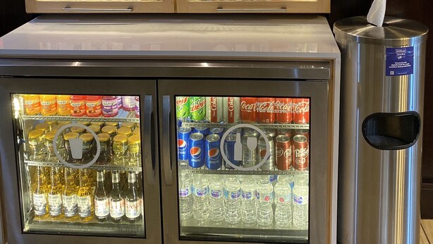 A vending machine with snacks, drinks, and toiletries. - Hampton Inn Raleigh/Clayton I-40 (Garner)