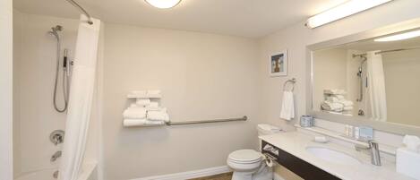 A modern bathroom with a bathtub, toilet, and sink.