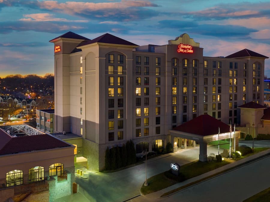 A large hotel with multiple floors, a prominent entrance, and a well-lit facade.