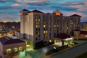 A large hotel with multiple floors, a prominent entrance, and a well-lit facade.