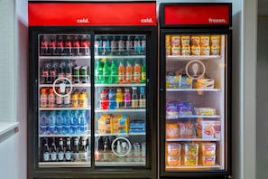 Two beverage vending machines with separate sections for cold and frozen drinks. - Hampton Inn & Suites Kansas City-Country Club Plaza (Kansas City)