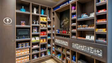 A well-organized pantry with various food items and a chalkboard sign welcoming visitors to Kansas City.