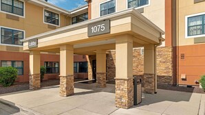 A building entrance with a covered lobby area, numbered 1075, and a sign indicating the lobby.