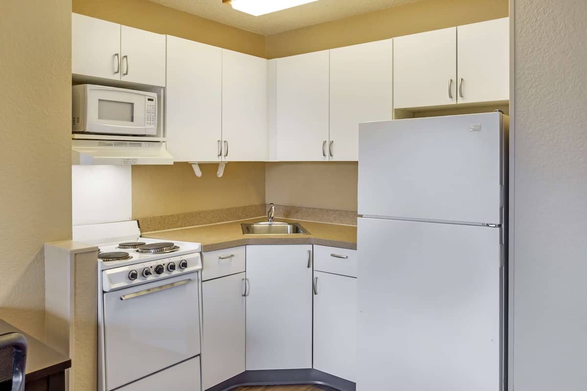 full-sized fridge, microwave, stovetop, coffee/tea maker