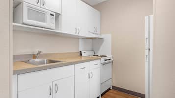 Studio, 1 Queen Bed, Non Smoking | Private kitchen | Full-size fridge, microwave, stovetop, cookware/dishes/utensils