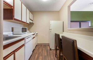 Full-size fridge, microwave, stovetop, cookware/dishes/utensils