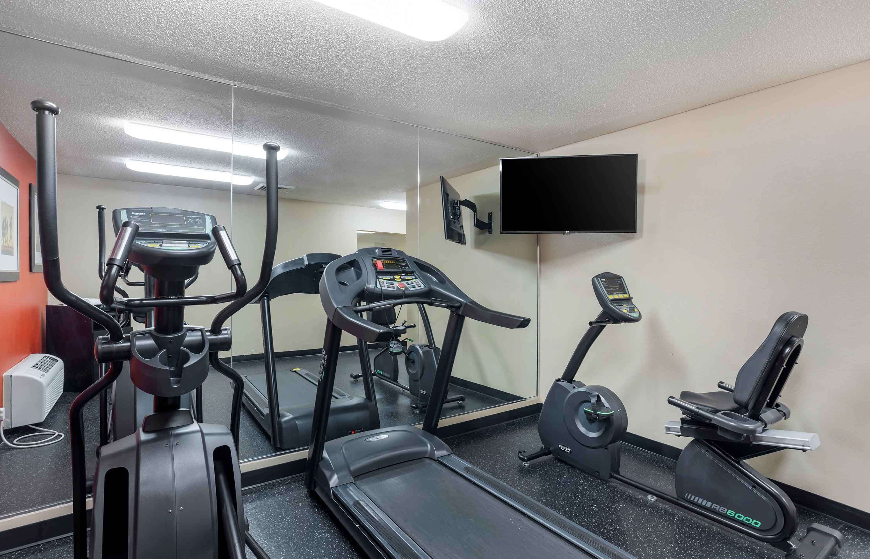 A gym with treadmills, an elliptical, and a stationary bike.