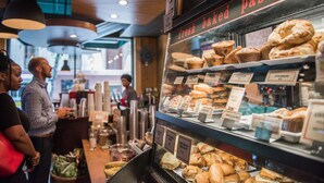 A bakery display case with various baked goods and a sign reading "fresh baked pastries". - Magnolia Hotel Dallas Downtown (Dallas)