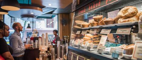 A bakery display case with various baked goods and a sign reading "fresh baked pastries".