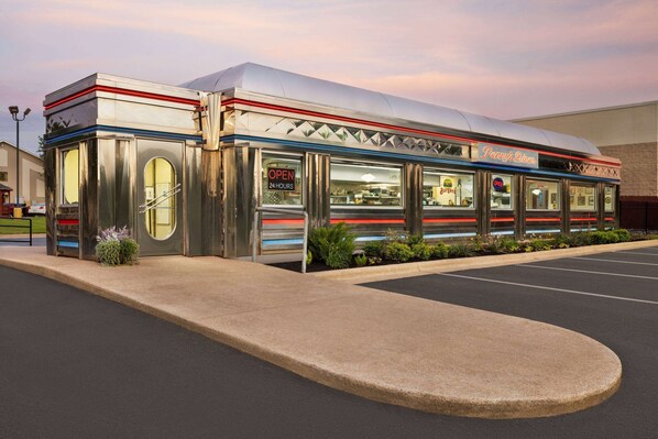 A diner with a retro design, featuring a large awning and a sign that reads "Penn's Diner."