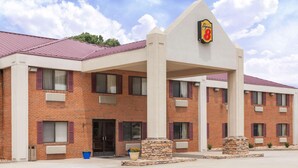 A Super 8 hotel with a brick facade, multiple windows, and a distinctive logo on the entrance.