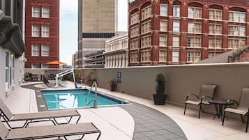 Relax by the rooftop pool with a view of the city.