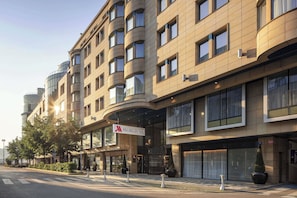 A multi-story hotel with a modern architectural design, featuring a prominent 'Marriott' sign.
