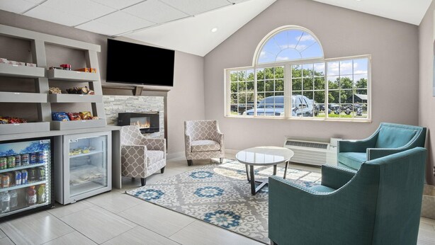 A modern living room with a fireplace, television, and seating area.