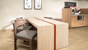 A modern kitchen with a wooden countertop, a built-in oven, and a coffee station. - Candlewood Suites Charleston Mt Pleasant by IHG (Mount Pleasant)