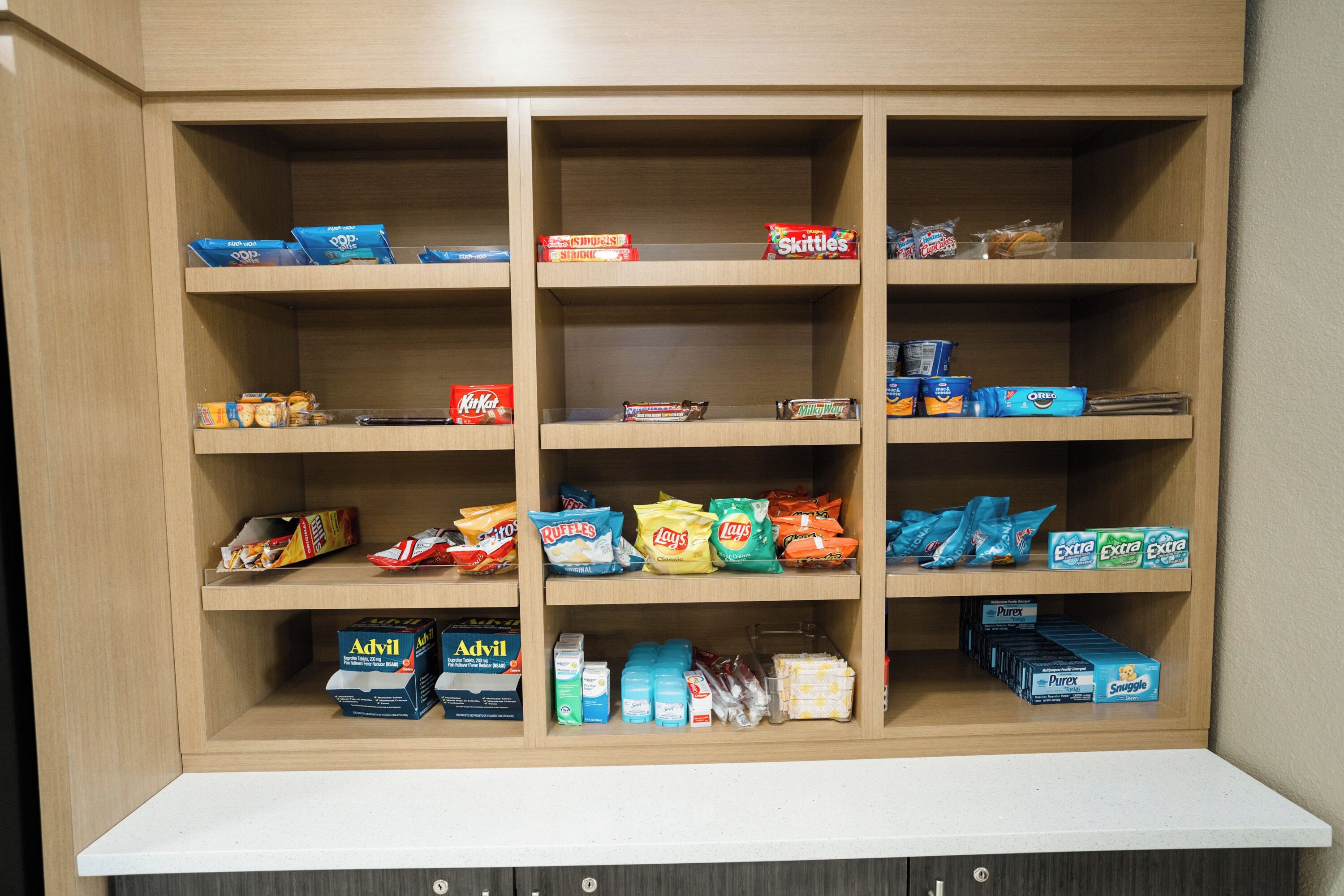 A storage cabinet with multiple shelves containing various food and household items.