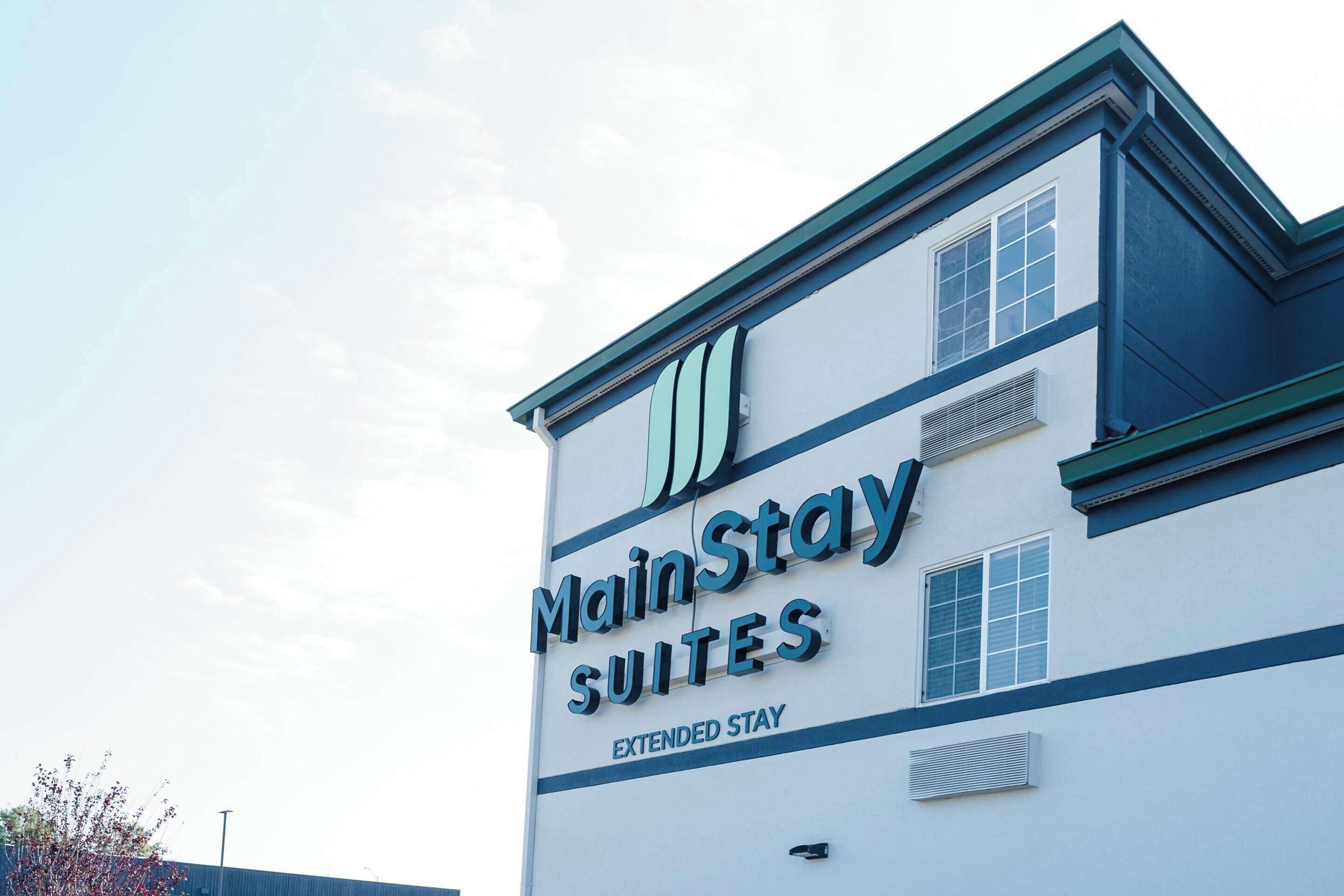 A MainStay Suites building with a sign indicating extended stay accommodations.