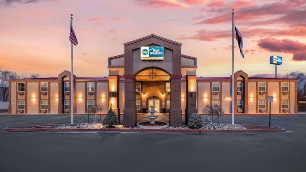 A Best Western hotel with a symmetrical facade, a central entrance, and a landscaped area with a fountain. - Best Western Executive Inn & Suites (Colorado Springs)