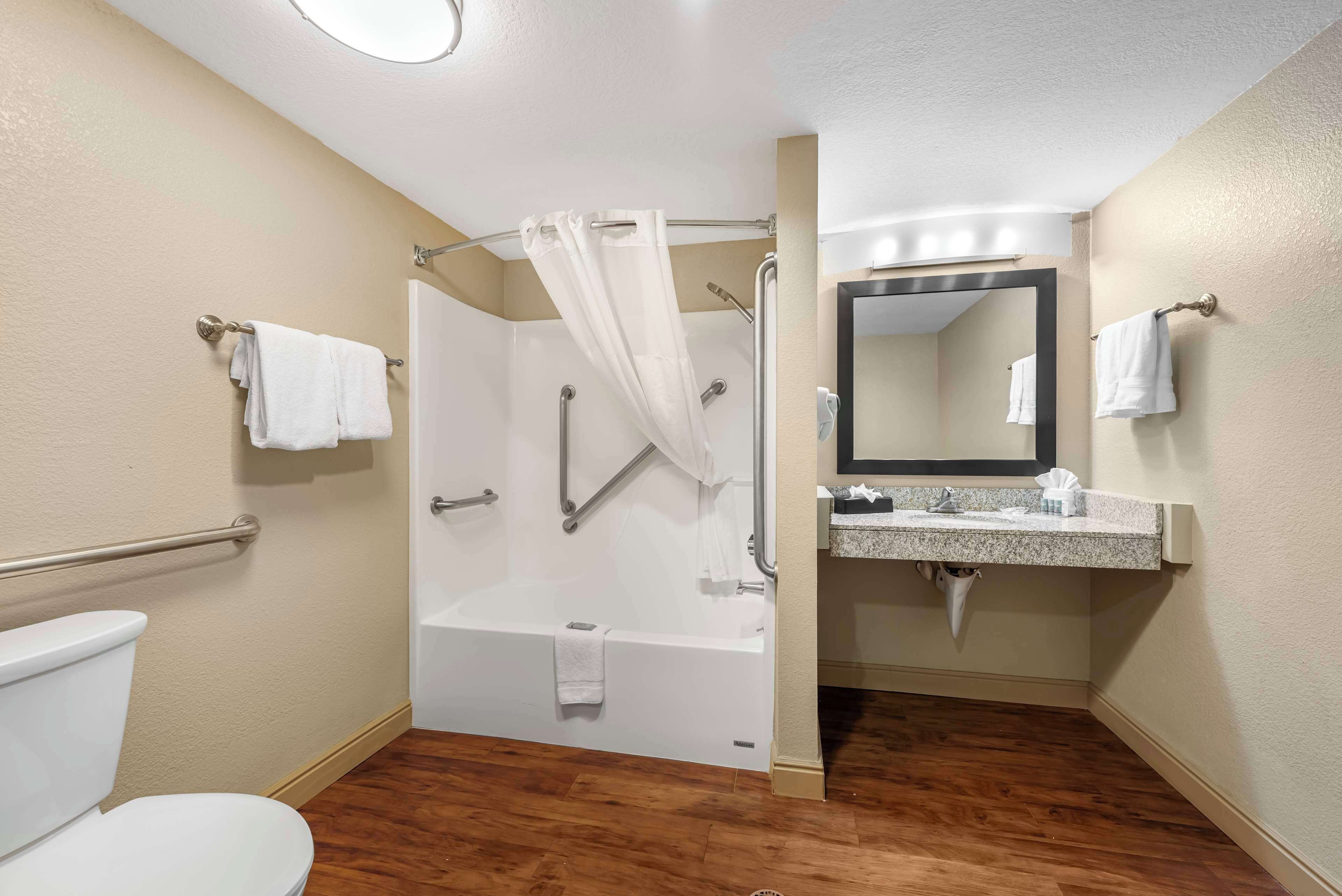 A bathroom with a bathtub, toilet, and sink.