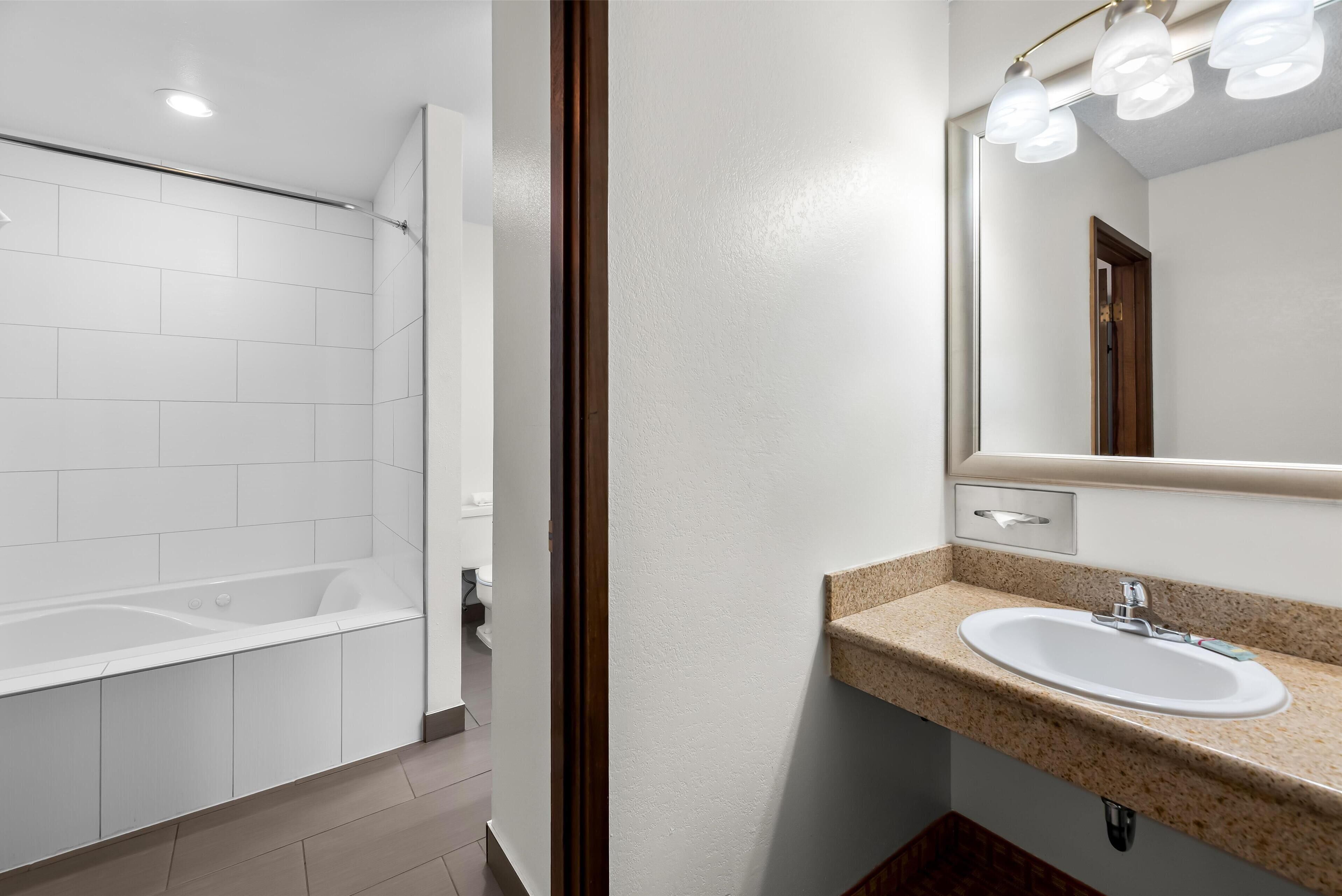 standard room, 1 king bed, non smoking, hot tub (larger room;with sofabed) | bathroom | combined shower/bathtub, free toiletries, hair dryer, towels