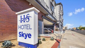 A hotel sign with the name "Hotel Skye" and a clear view of the entrance.