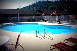Seasonal outdoor pool, open 9 AM to 9:00 PM, pool umbrellas