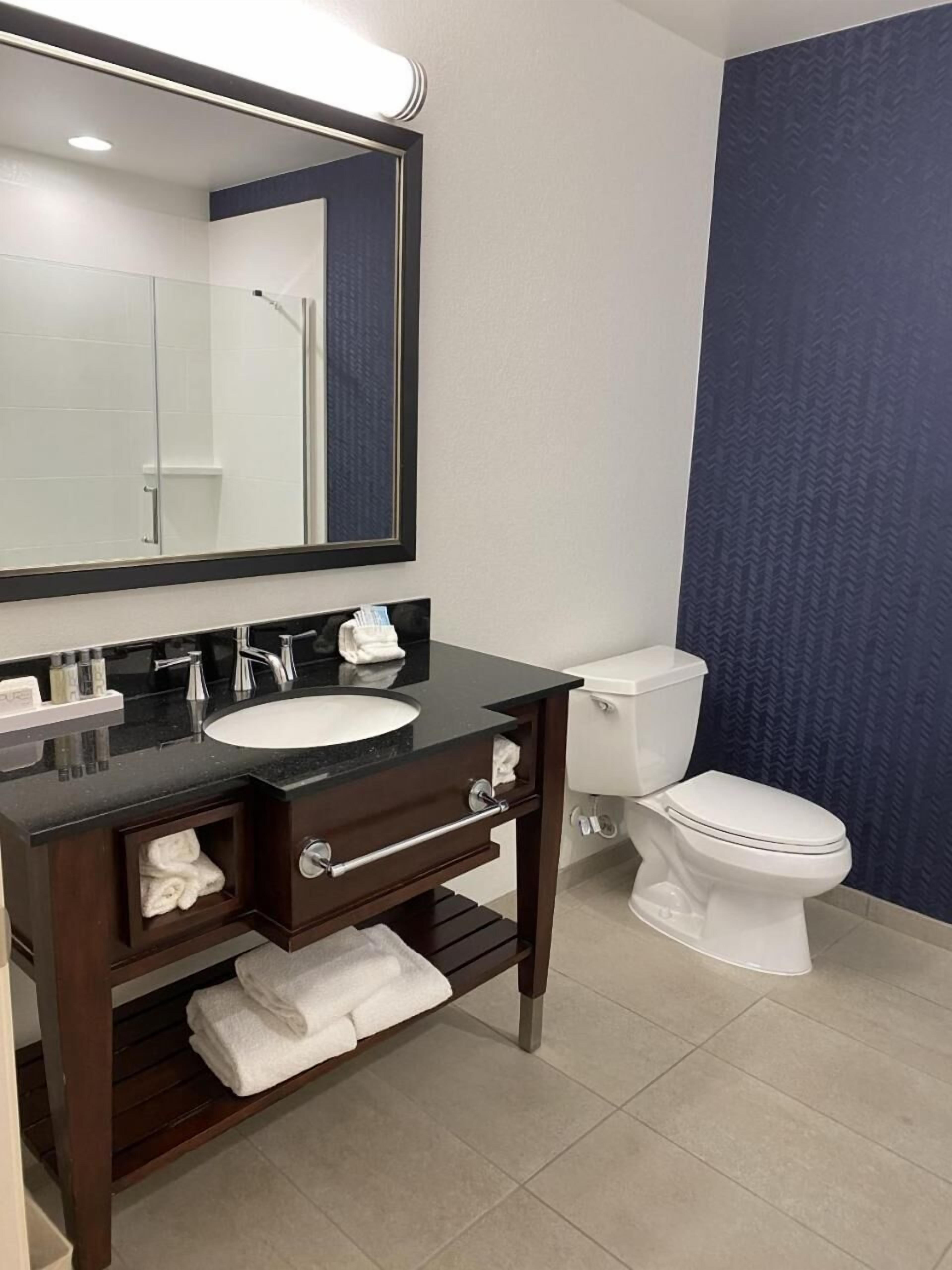 shower, designer toiletries, hair dryer, towels