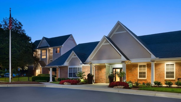 A row of modern, two-story buildings with a uniform architectural style, featuring pitched roofs and brick facades. - Sonesta ES Suites Atlanta Alpharetta North Point Mall (Alpharetta)