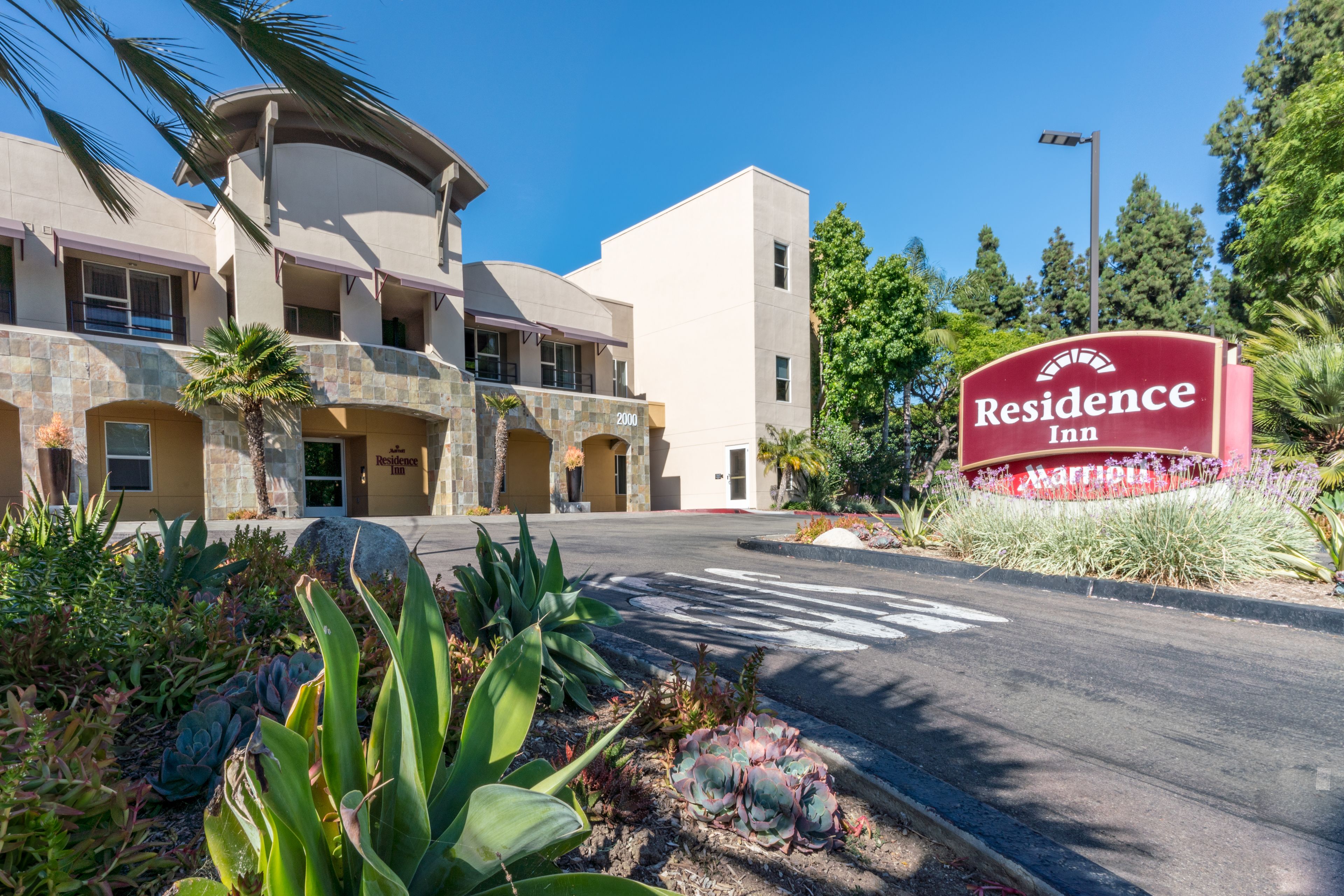 A Residence Inn hotel with a stone facade, multiple balconies, and a landscaped entrance area.