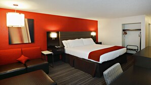 A hotel room with a large bed, a desk, a chair, a sofa, and a wardrobe. - Holiday Inn Express Brentwood South - Cool Springs by IHG (Brentwood)