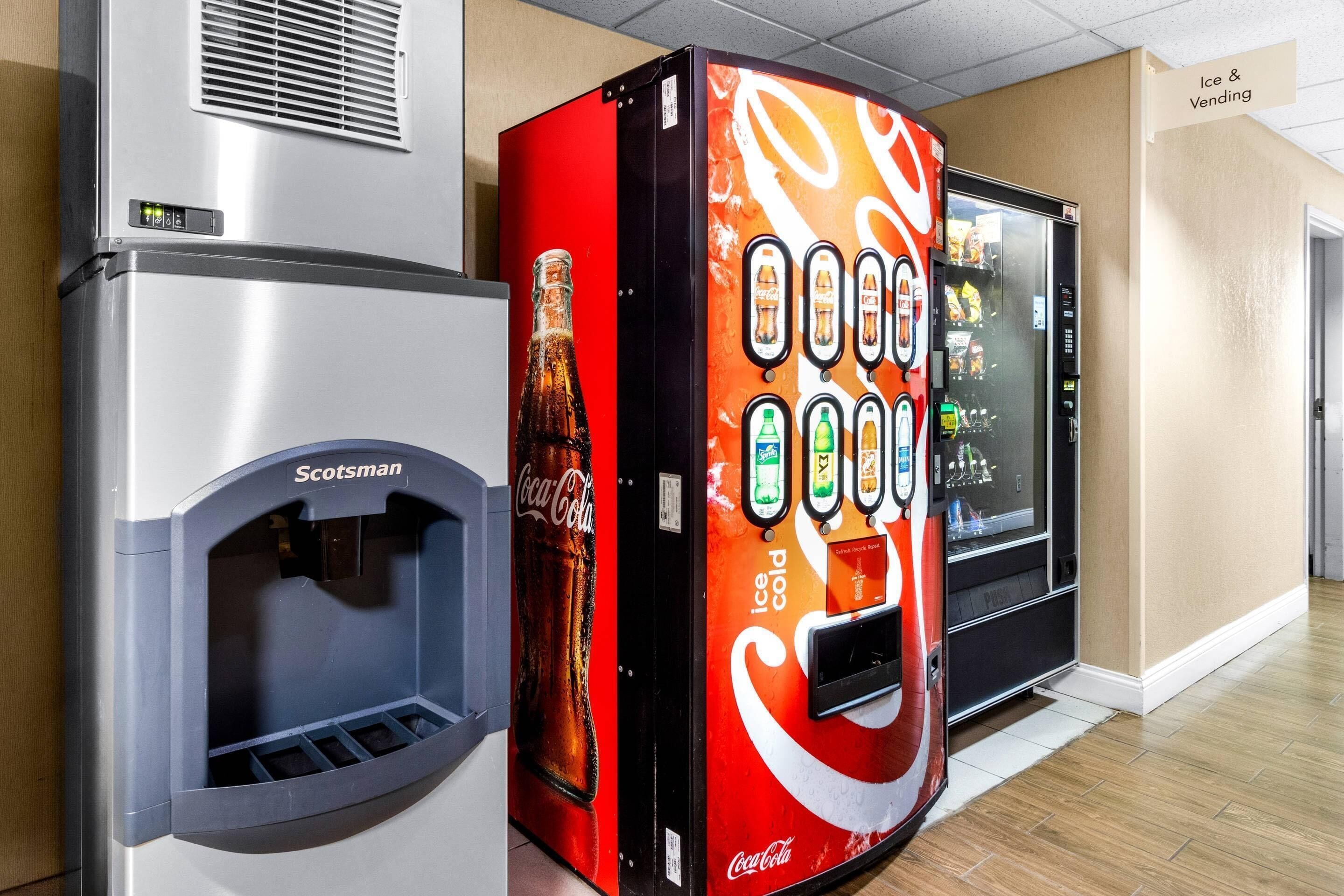A vending machine with a Coca-Cola logo, a water dispenser, and a refrigerator.